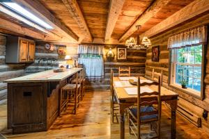 a kitchen with wooden walls and a table and chairs at Chestnut Lodge - Family Cabin on Lake Nantahala in Topton