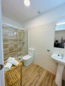 a bathroom with a toilet and a sink and a shower at HOSTEL COSTA-LUZ Béjar in Huelva