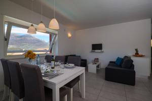 a dining room with a table and chairs with a view at Residence Girasole Casa Rossa B in Colico