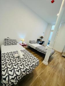 a bedroom with a black and white bed and a ladder at HOSTEL COSTA-LUZ Béjar in Huelva