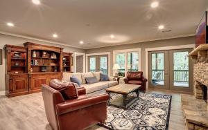 a living room with a couch and a fireplace at Wilderness Lodge - Fireside Chats Spa Baths in Afton