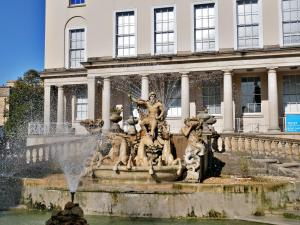 a fountain in front of a building at Hill View House in Cheltenham