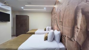 Ένα ή περισσότερα κρεβάτια σε δωμάτιο στο Celia Pyramids View inn