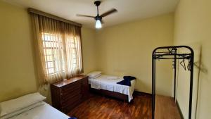 a bedroom with a bed and a fan at Casa espaçosa e confortável na região da Pampulha in Belo Horizonte +37 photos