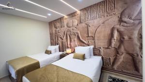 Ένα ή περισσότερα κρεβάτια σε δωμάτιο στο Celia Pyramids View inn