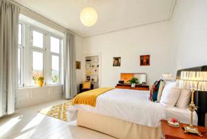 a white bedroom with a large bed and a window at Dairsie Sea View in Rothesay