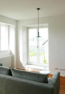 a living room with a couch and a window at Haus Münsterblick in Reichenau