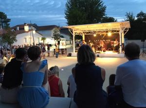 a group of people watching a band playing at a concert at La Casita - Ronce les bains in La Tremblade +29 photos