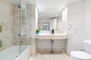 a bathroom with a sink and a shower and a toilet at Gorgeous Studio right in the heart of Surfers in Gold Coast