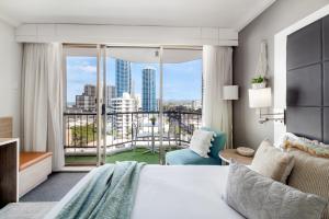 a bedroom with a bed and a view of a city at Gorgeous Studio right in the heart of Surfers in Gold Coast