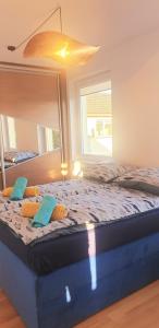 a large bed in a bedroom with a large mirror at Apartament Na Wydmie, garaż + ładowarka EV in Ustka