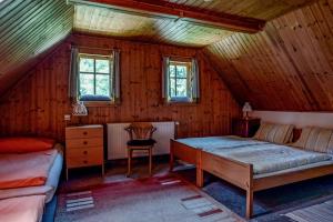 a bedroom with a bed and a desk in a room at Chalupa Bedřichov in Bedřichov