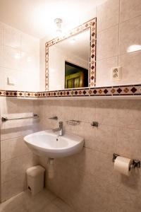 a bathroom with a sink and a mirror at Chalupa Bedřichov in Bedřichov