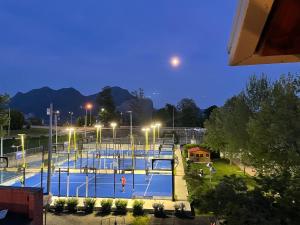 a view of a tennis court at night at Al Centro in Verbania