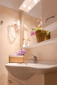 a bathroom with a sink and a mirror at Martha's filoxenia in Drios +42 photos