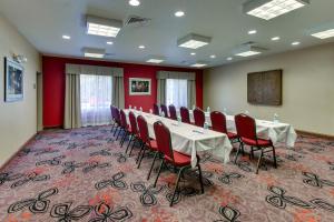 a conference room with a long table and red chairs at Holiday Inn Express Hotel & Suites Lancaster-Lititz by IHG in Lititz