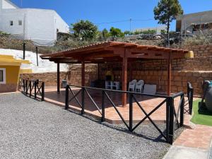 a gazebo with a table and chairs in it at Casa Cueva Los Mansos in Santa Cruz de Tenerife