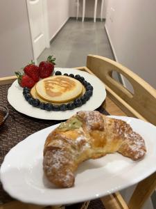 a pastry on a plate with a cup of coffee and strawberries at Anfitrite B&B Tropea in Tropea +21 photos