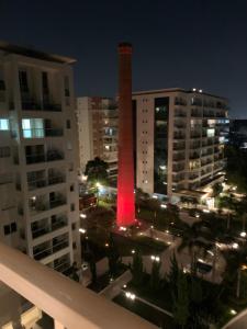 a tall tower in the middle of a city at night at Modernidade e conforto para sua hospedagem !!! in Sao Paulo