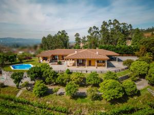 an aerial view of a house with a pool at Quinta Devesa do Monte in Amares