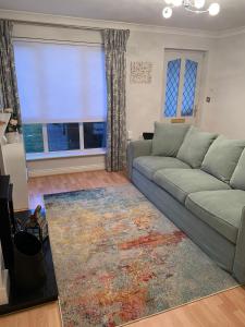 a living room with a couch and a large window at Inse House Laytown in Laytown