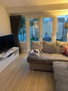 a living room with a couch and a flat screen tv at Inse House Laytown in Laytown