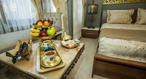 a bedroom with a tray of fruit on a bed at Million Old City Apartment in Istanbul +36 photos