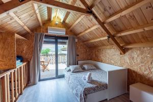 a bedroom with a bed and a balcony at Acogedora casita en la Subbética, centro de Andalucía, Granada y Córdoba in Zambra +60 photos