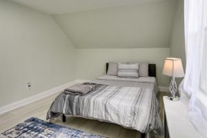 a bedroom with a bed with a lamp and a rug at Jersey City Vacation Rental about 8 Mi to NYC! in Jersey City