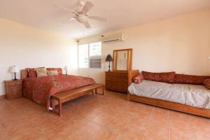 a bedroom with two beds and a ceiling fan at Perfect for destination weddings & family vacations! in Arecibo