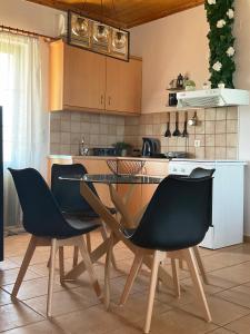 a kitchen with a table and chairs in a kitchen at Vlastaras Apartment in Sivota