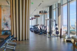 a gym with a row of treadmills and machines at Luxury Condo with Spectacular Ocean View in Hollywood