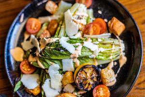 a plate of food with vegetables on a table at Renaissance St. Augustine Historic Downtown Hotel in Saint Augustine