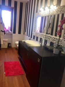a bathroom with a sink and a mirror at ATTICO LUX LE GRU in Grugliasco