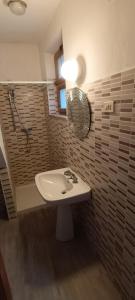 a bathroom with a sink and a mirror at Occitania in Gravere