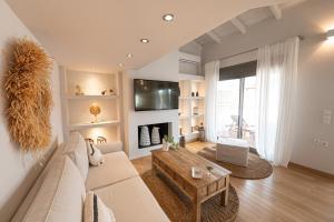 a living room with a couch and a table at Orsalia villa wellness in Poros