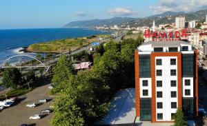 a building on the side of a beach next to the ocean at Ramada By Wyndham Vakfıkebir in Trabzon