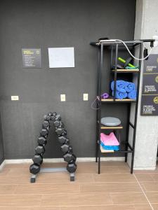 a room with a gym with a rack of weights at Factory Lofts Hotel in Medellín