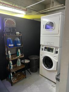 a laundry room with a washing machine in it at Factory Lofts Aparthotel in Medellín