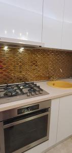 a kitchen with a stove and a sink at KYA Luxury in Mamaia