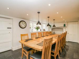 a large dining room with a large wooden table and chairs at Viaduct House in Lydbrook