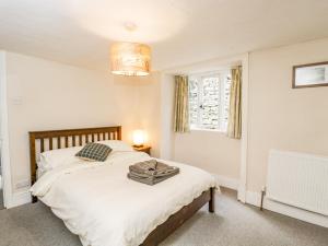 a bedroom with a bed and a window at Viaduct House in Lydbrook