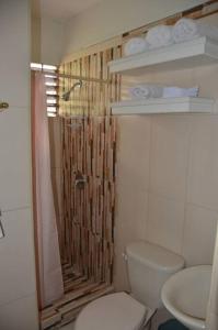 a bathroom with a shower and a toilet and a sink at 1 Bedroom Upscale Apt in Kingston