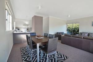 a kitchen and living room with a table and chairs at Julieanne in Port Fairy