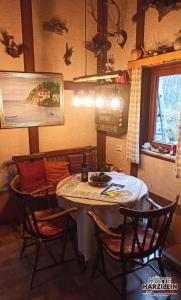 a dining room with a table and chairs and a window at Arode Hütte Harzilein - Romantic tiny house on the edge of the forest in Zorge