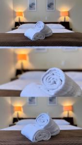 a group of beds with white towels on them at Binder Hotel Mogi Guaçu in Mogi Guaçu