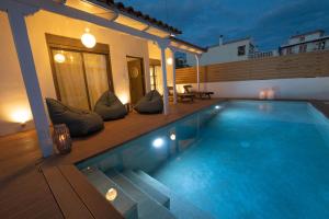 a swimming pool in the middle of a house at Orsalia villa wellness in Poros