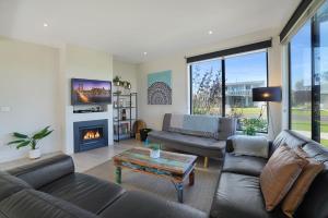 a living room with a couch and a fireplace at Bliss at South Beach in Port Fairy