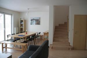 a dining room and living room with a table and chairs at Holiday Home Prague Pruhonice in Pruhonice