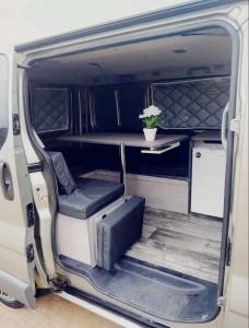 an open door of a van with a plant in the back at Autocaravana Camper in Las Palmas de Gran Canaria